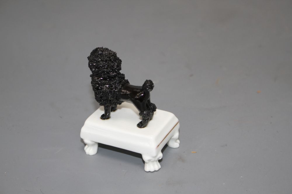 A rare Staffordshire small porcelain figure of a black poodle, c.1830-50, H. 7.5cm
